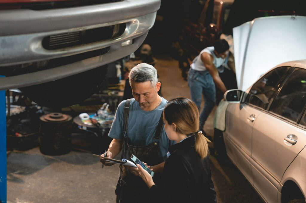 customer making inspection check to a car engine repair occupation job at garage service
